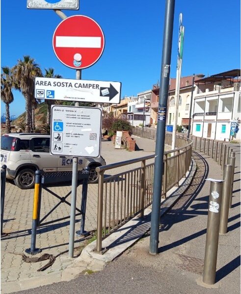 Road signs and camper parking area near residential buildings