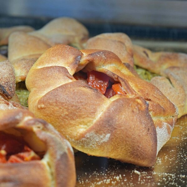 Freshly baked stuffed focaccia with tomatoes and vegetables